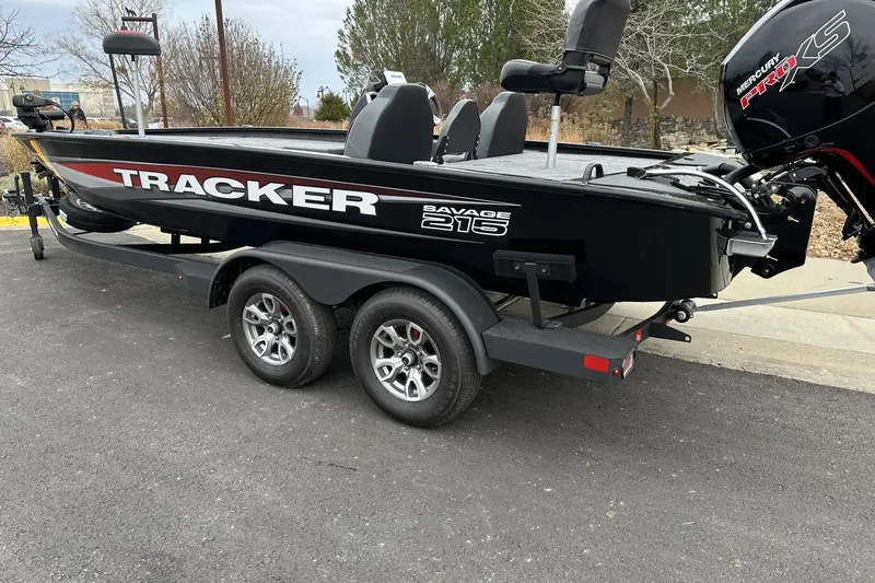 The Image of 2025 Tracker Savage 215 boat on trailer, featuring sleek black design and Mercury Pro XS engine. - 0
