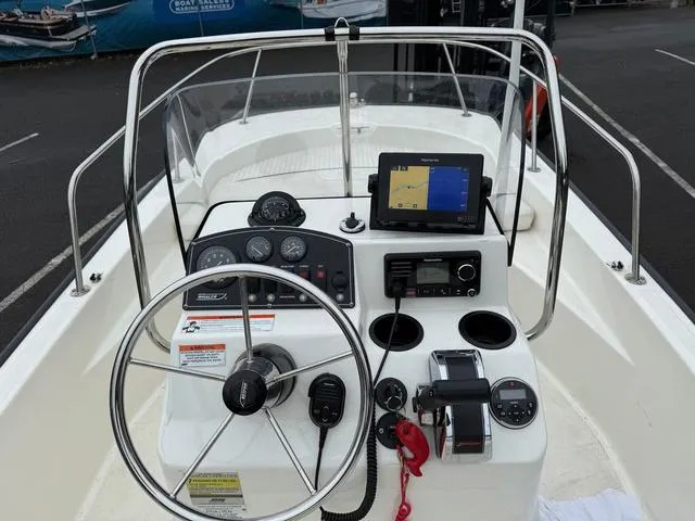 Slide: The Image of Boston Whaler 170 Montauk 2010 boat dashboard with steering wheel and navigation equipment. - 3