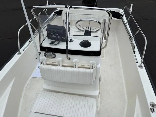 Slide: The Image of 2010 Boston Whaler 170 Montauk boat interior with steering console and seating. - 4