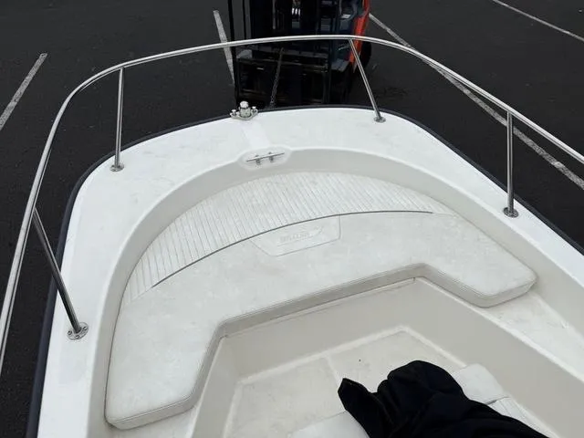 Slide: The Image of 2010 Boston Whaler 170 Montauk boat interior with white seating and railing. - 5
