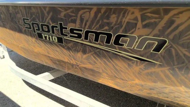 Slide: The Image of 2025 G3 Sportsman 1710 boat with camouflage design on trailer. - 10