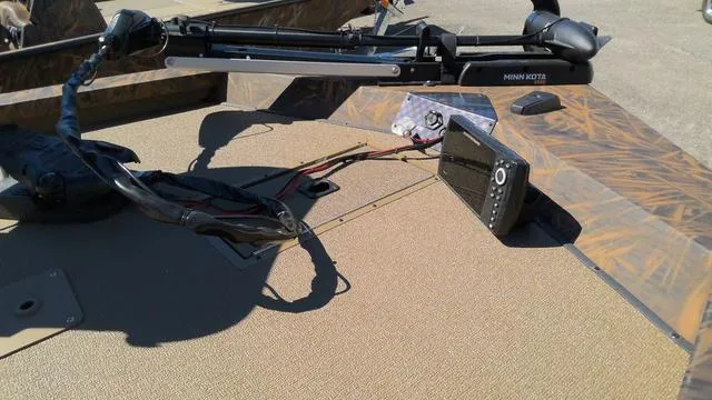 Slide: The Image of 2025 G3 Sportsman 1710 boat deck with Minn Kota trolling motor and fish finder. - 2