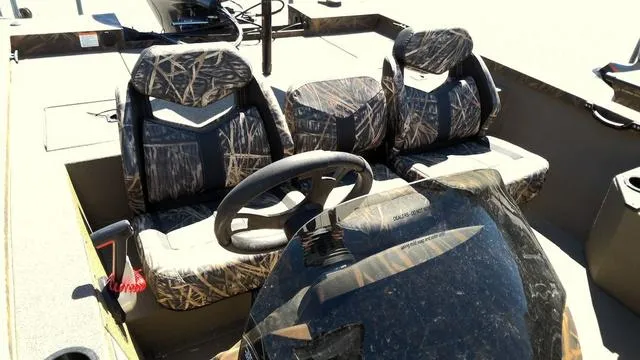 Slide: The Image of 2025 G3 Sportsman 1710 boat interior with camo seats and steering wheel. - 4