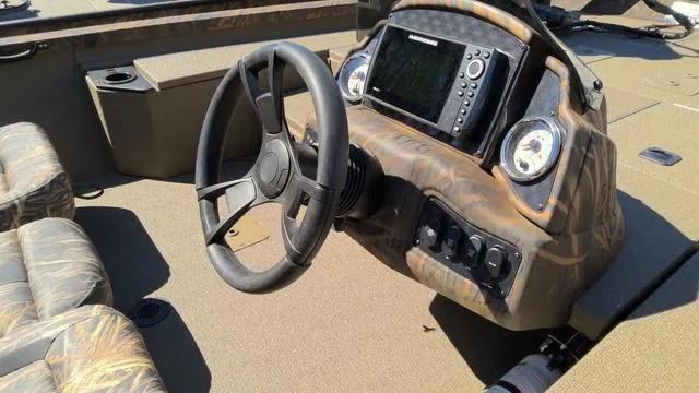 Slide: The Image of 2025 G3 Sportsman 1710 boat dashboard with steering wheel and navigation system. - 5