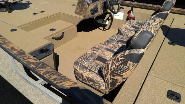 Slide: The Image of 2025 G3 Sportsman 1710 boat interior with camouflage seats and steering wheel. - 9