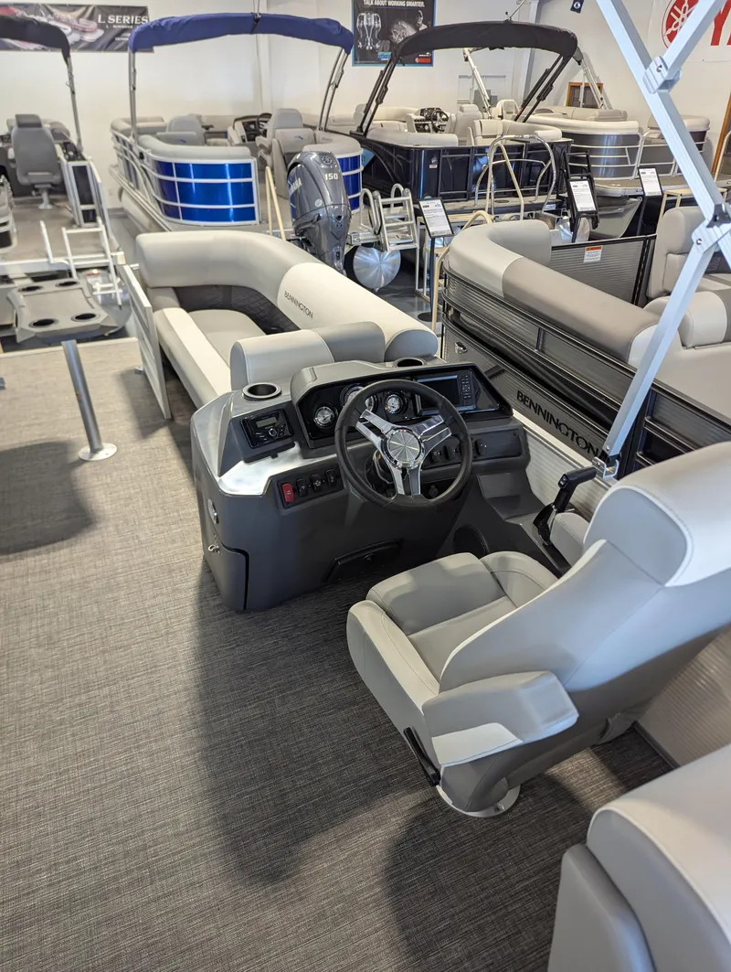 Slide: The Image of 2024 Bennington 22SSR pontoon boat interior with steering console and seating. - 5