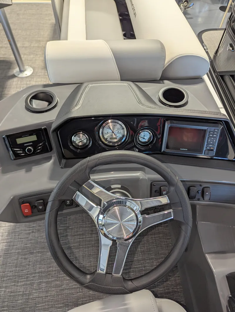 Slide: The Image of 2024 Bennington 22SSR boat dashboard with steering wheel and instrument panel. - 6