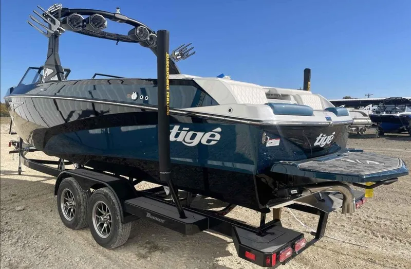 Slide: The Image of 2024 Tigé Z5 boat on trailer, sleek design, blue and white color scheme. - 1