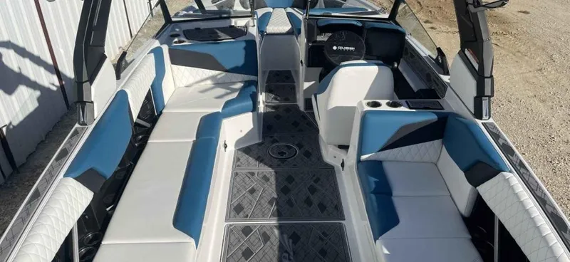 Slide: The Image of 2024 Tigé Z5 boat interior with blue and white seating, modern design, and spacious layout. - 2