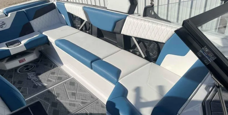 Slide: The Image of 2024 Tigé Z5 boat interior with blue and white seating and modern design. - 4