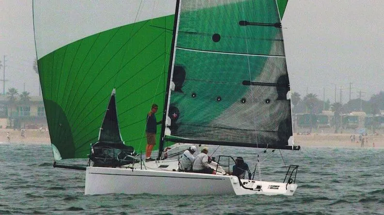 Slide: The Image of Columbia Yacht 32 sailing with green spinnaker, 2012 model, on open water. - 1