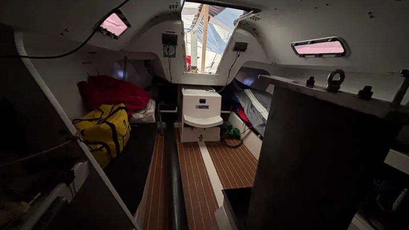 Slide: The Image of Interior of 2012 Columbia Yacht 32, featuring cozy sleeping quarters and wooden flooring. - 17
