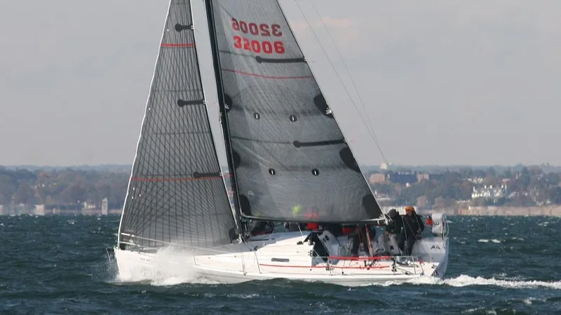 Slide: The Image of Columbia Yacht 32 sailing on open water, 2012 model, with crew onboard. - 2