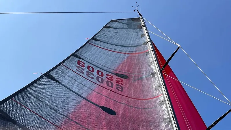 Slide: The Image of Sail of a 2012 Columbia Yacht 32 against a clear blue sky. - 4
