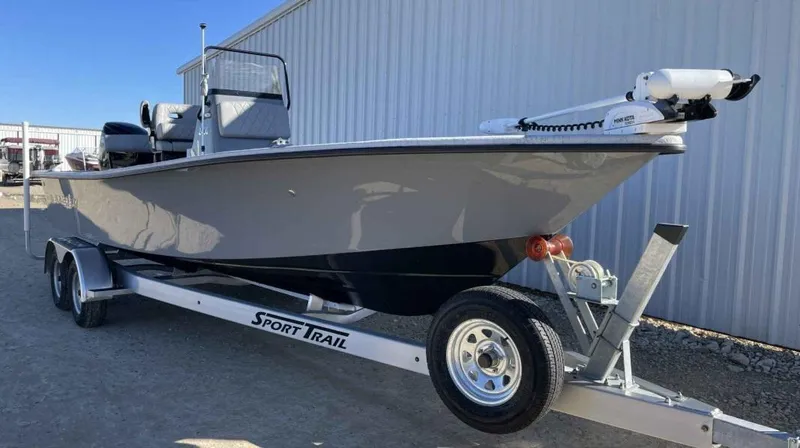 Slide: The Image of 2024 Blazer Bay 2400 boat on Sport Trail trailer, parked outdoors. - 14