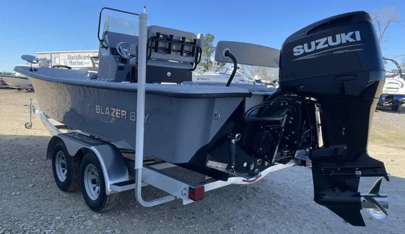 Slide: The Image of 2024 Blazer Bay 2400 boat with Suzuki outboard motor on a trailer. - 15
