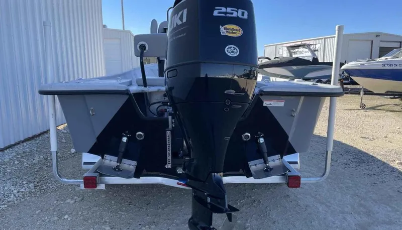 Slide: The Image of 2024 Blazer Bay 2400 boat with Suzuki 250 outboard motor, parked outdoors. - 17