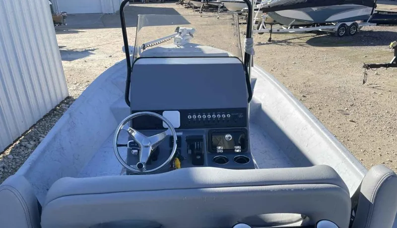 Slide: The Image of 2024 Blazer Bay 2400 boat interior with steering wheel and control panel. - 18