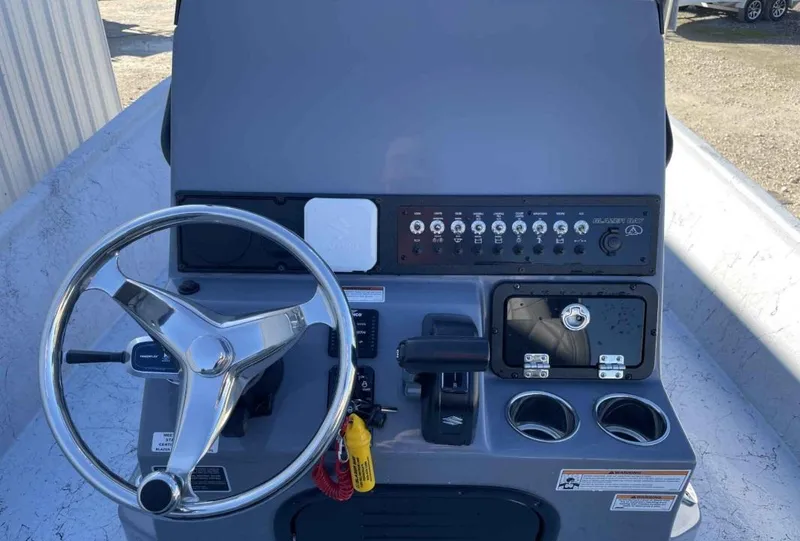 Slide: The Image of 2024 Blazer Bay 2400 boat console with steering wheel and control panel. - 19
