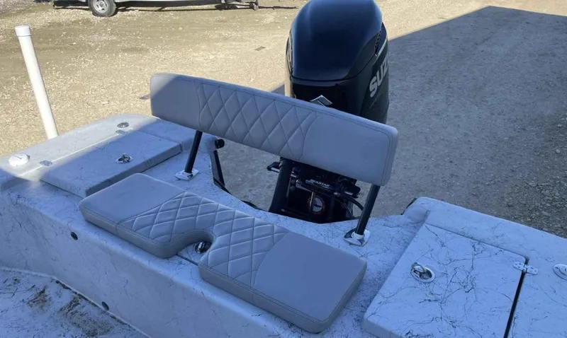 Slide: The Image of 2024 Blazer Bay 2400 boat with cushioned seating and outboard motor. - 22