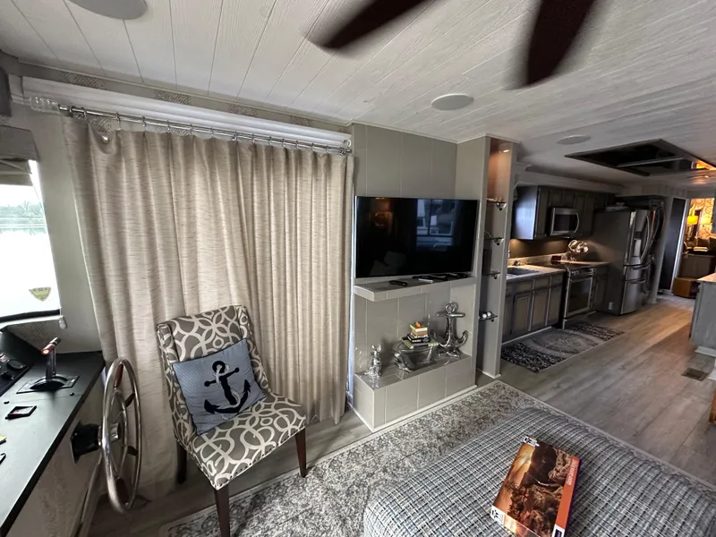 Slide: The Image of Interior of a 1991 Sumerset 14x60 houseboat with modern decor and kitchen. - 3