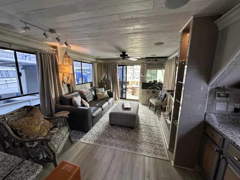 Slide: The Image of Interior of a 1991 Sumerset 14x60 houseboat with cozy living area and elegant decor. - 4