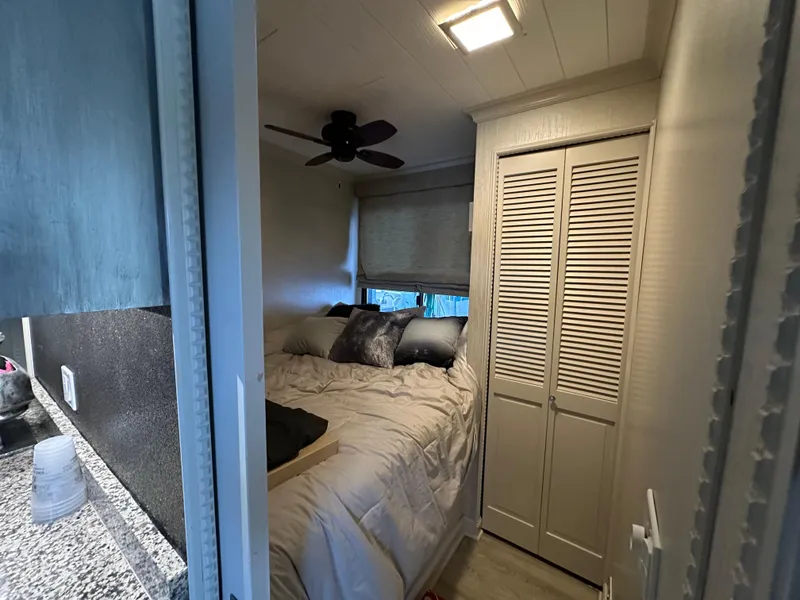 Slide: The Image of Cozy bedroom in 1991 Sumerset 14x60 houseboat with bed, closet, and ceiling fan. - 5