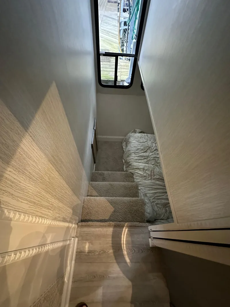 Slide: The Image of Staircase inside a 1991 Sumerset 14x60 houseboat, leading to a cozy sleeping area. - 7