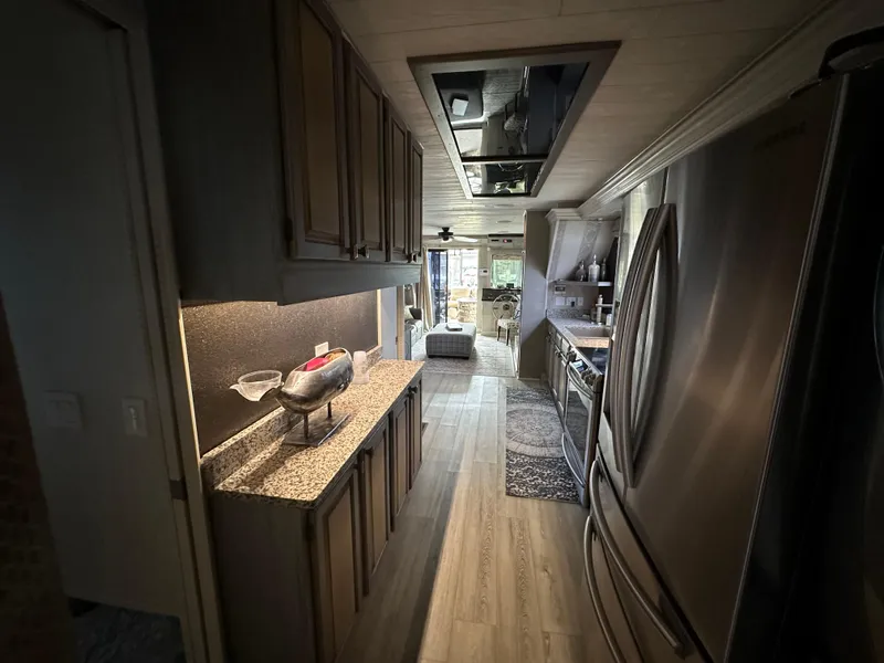 Slide: The Image of Interior of a 1991 Sumerset 14x60 houseboat kitchen with modern appliances and wood flooring. - 8