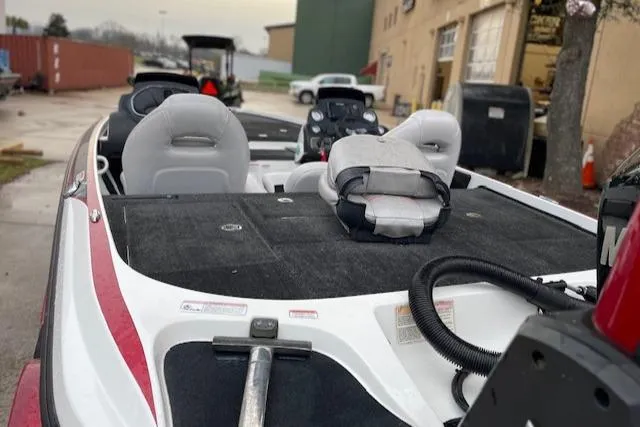 Slide: The Image of 2016 Nitro Z21 boat interior with seats and equipment, parked outdoors. - 3