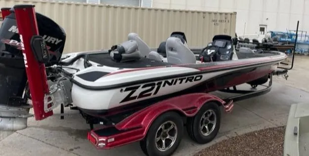 Slide: The Image of 2016 Nitro Z21 boat with Mercury engine on a red trailer. - 6