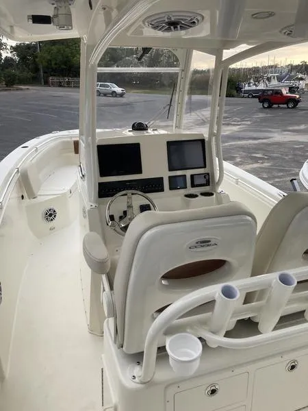 Slide: The Image of 2024 Cobia 262 CC boat interior with modern dashboard and seating. - 11