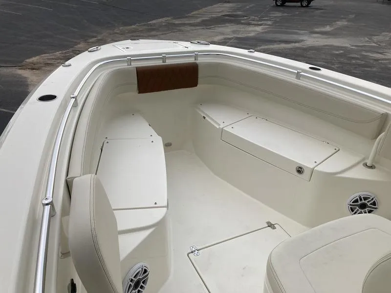 Slide: The Image of 2024 Cobia 262 CC boat interior with seating and storage compartments. - 13