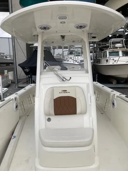 Slide: The Image of 2024 Cobia 262 CC center console boat with seating and overhead canopy. - 8