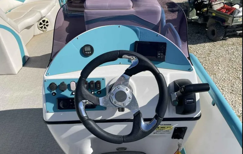 Slide: The Image of 2022 Aloha Pontoon Mahalo 250 dashboard with steering wheel and controls. - 10