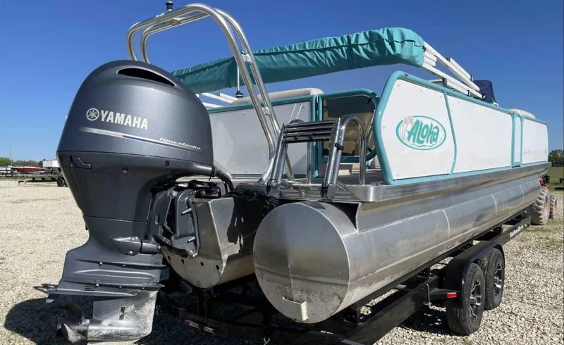 Slide: The Image of 2022 Aloha Pontoon Mahalo 250 with Yamaha engine on a trailer. - 4