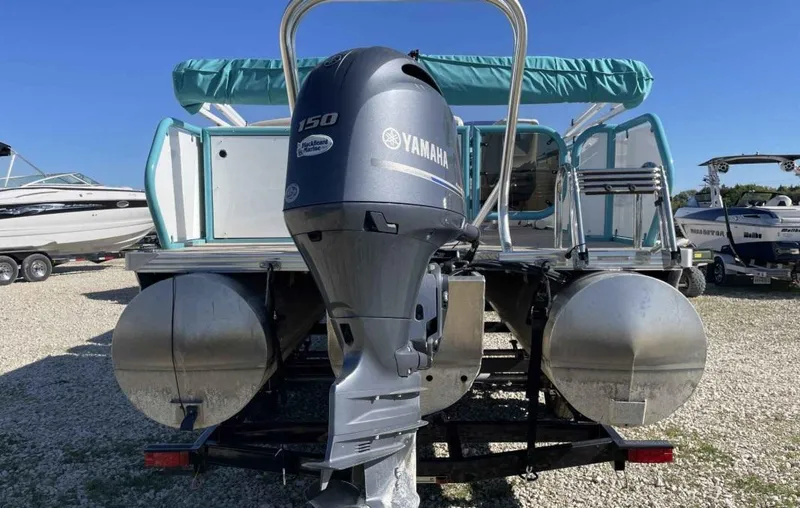 Slide: The Image of 2022 Aloha Pontoon Mahalo 250 with Yamaha engine, docked on gravel lot. - 5