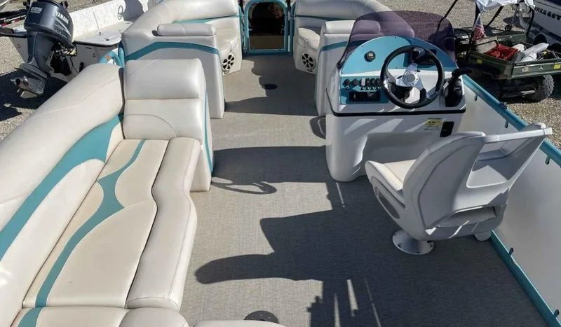 Slide: The Image of 2022 Aloha Pontoon Mahalo 250 interior with plush seating and modern helm. - 8