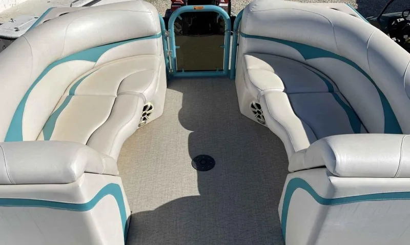 Slide: The Image of 2022 Aloha Pontoon Mahalo 250 interior with curved seating and teal accents. - 9