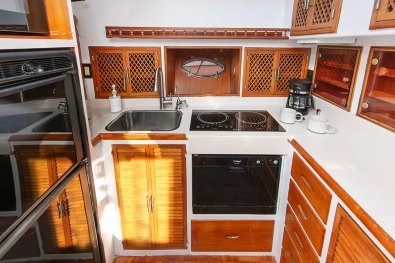 Slide: The Image of 1989 Lien Hwa Vitesse Yachtfisher kitchen with wooden cabinets and modern appliances. - 13