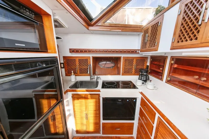 Slide: The Image of 1989 Lien Hwa Vitesse Yachtfisher kitchen with wood cabinetry and modern appliances. - 14