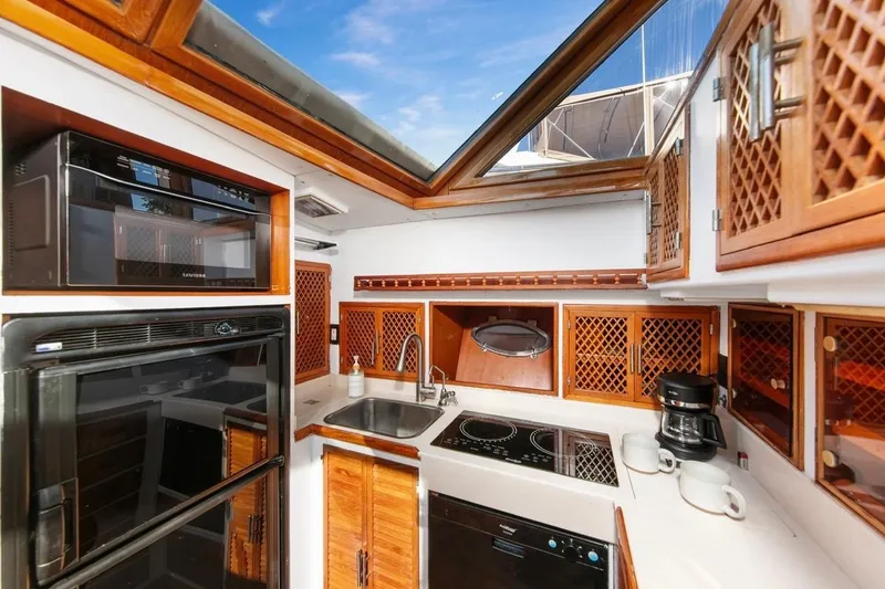 Slide: The Image of Luxurious 1989 Lien Hwa Vitesse Yachtfisher kitchen with wood cabinetry and modern appliances. - 15
