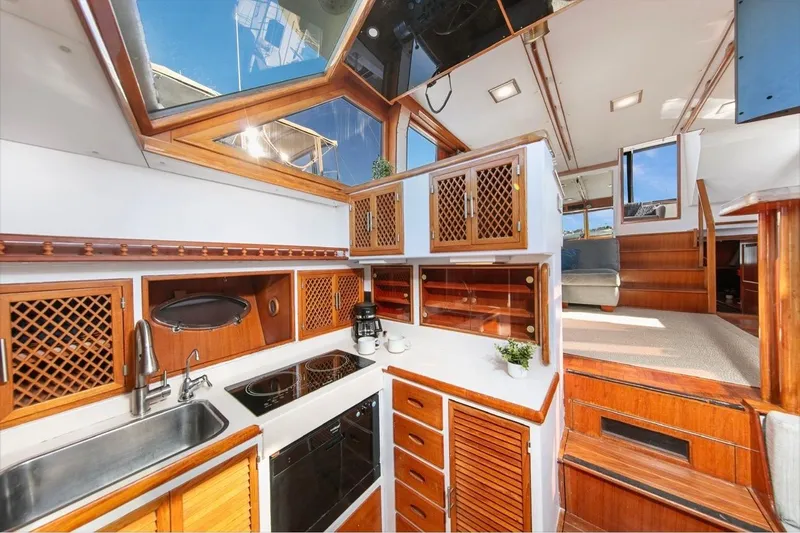 Slide: The Image of 1989 Lien Hwa Vitesse Yachtfisher interior with wooden cabinetry and modern kitchen amenities. - 16