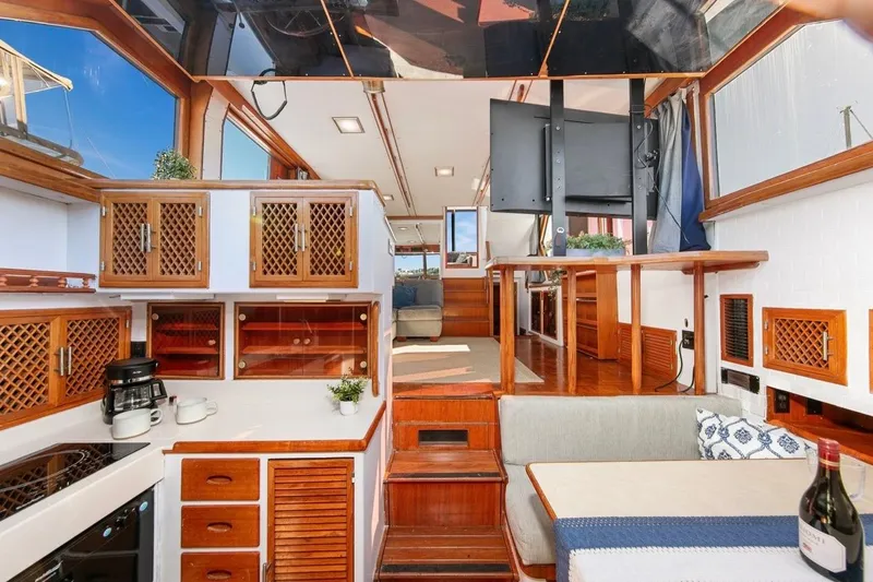 Slide: The Image of 1989 Lien Hwa Vitesse Yachtfisher interior with wood cabinetry, seating, and modern amenities. - 18