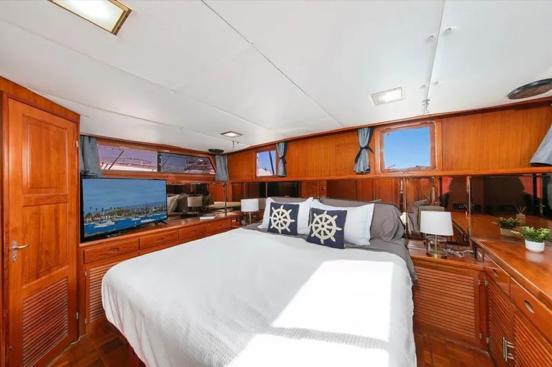 Slide: The Image of Luxurious 1989 Lien Hwa Vitesse Yachtfisher bedroom with wood paneling and nautical decor. - 20