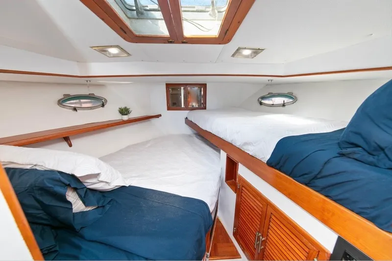 Slide: The Image of Interior cabin of 1989 Lien Hwa Vitesse Yachtfisher with cozy beds and wooden accents. - 24