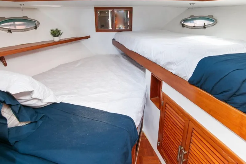 Slide: The Image of 1989 Lien Hwa Vitesse Yachtfisher cabin with cozy bunk beds and wooden accents. - 25