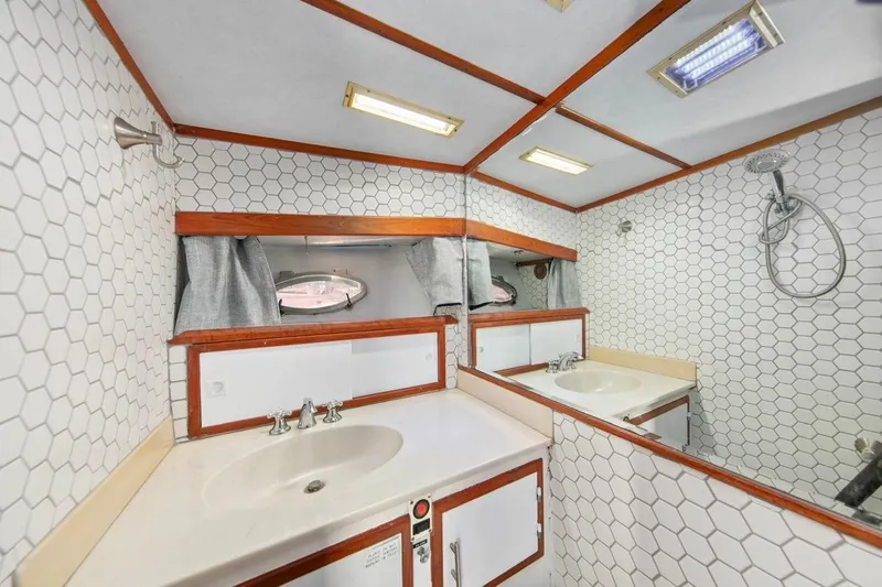 Slide: The Image of Bathroom interior of 1989 Lien Hwa Vitesse Yachtfisher with hexagonal tiles and wooden accents. - 28