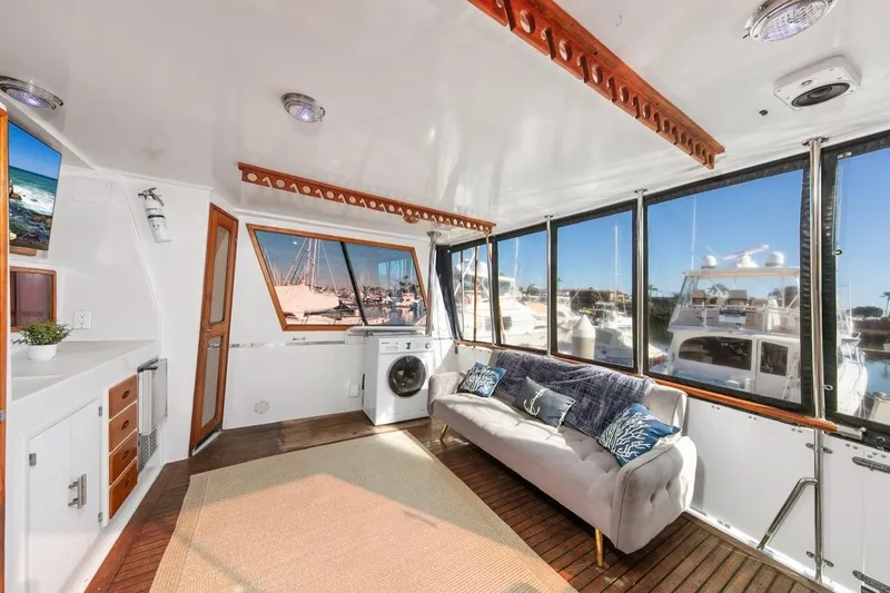 Slide: The Image of 1989 Lien Hwa Vitesse Yachtfisher interior with sofa, washer, and marina view. - 29