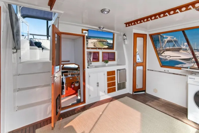 Slide: The Image of 1989 Lien Hwa Vitesse Yachtfisher interior with wooden accents and marina view. - 32